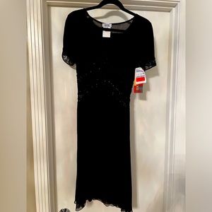 Edgy black dress for night out with impeccable detail’